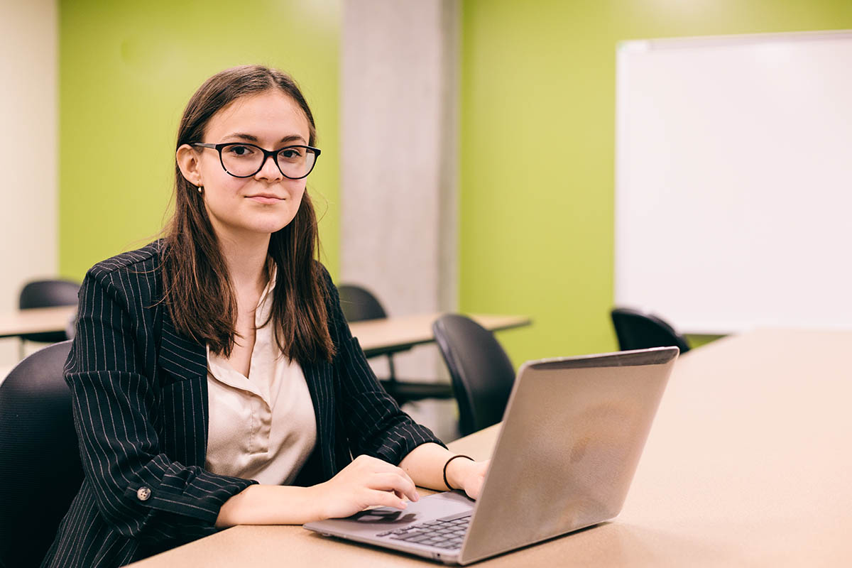 Student Yana Petrova works at a laptop